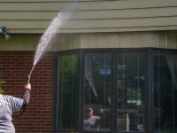 Man,Is,Seen,With,A,Spray,Nozzle,In,His,Hand.