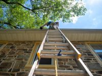 Man,On,A,Ladder,Cleans,The,Gutters,On,An,Old